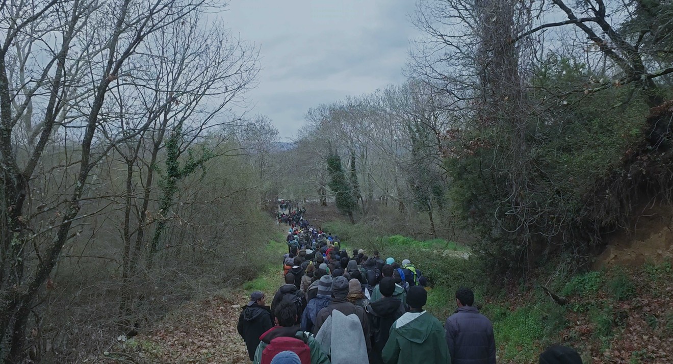 Refugees walk near Idomeni Camp on Greece's northern border in Chinese artist/activist Ai Weiwei's Human Flow, the epic new documentary that surveys the scope of a global crisis.