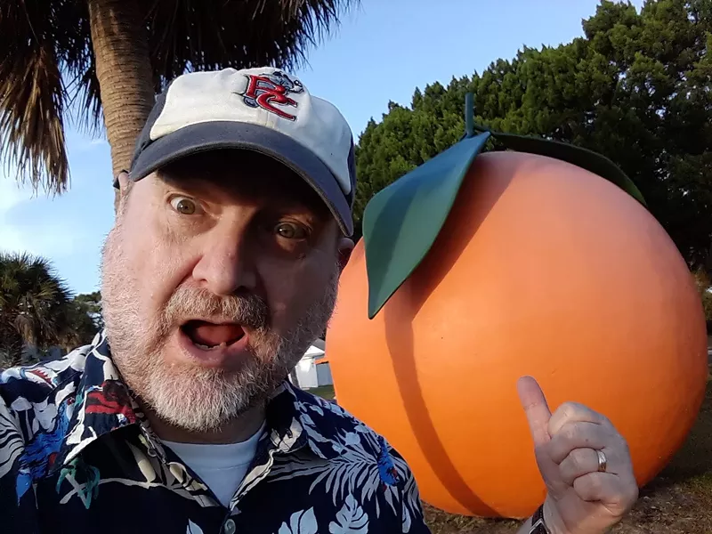 Image: selfie of Craig Pittman in front of a sculpture of an orange