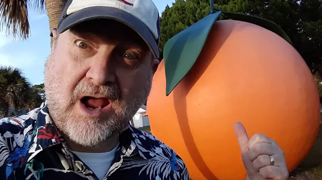 selfie of Craig Pittman in front of a sculpture of an orange
