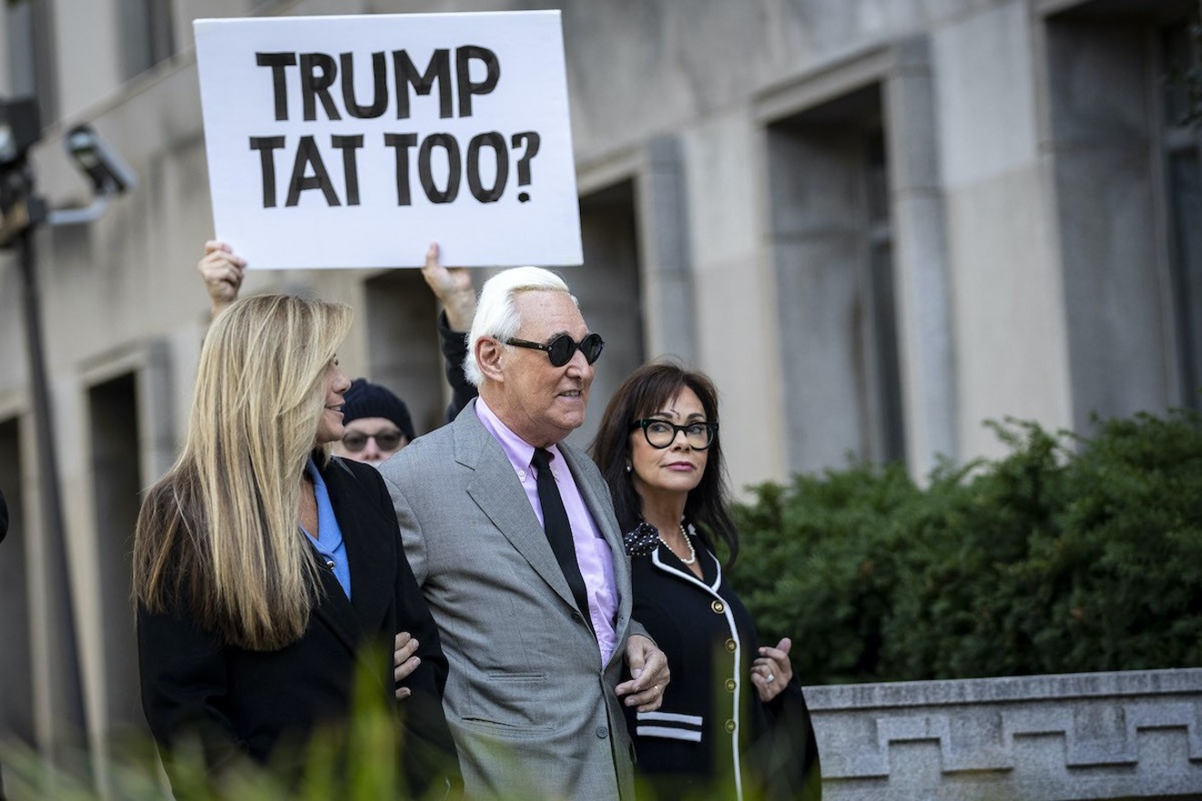 Roger Stone walks with his wife Nydia Stone and his legal team as he arrives for the first day of his trial in Washington, D.C.