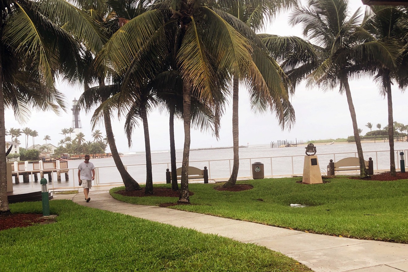 A parkgoer risks the light rain and winds from Dorian at Hillsboro Inlet Park on Monday.