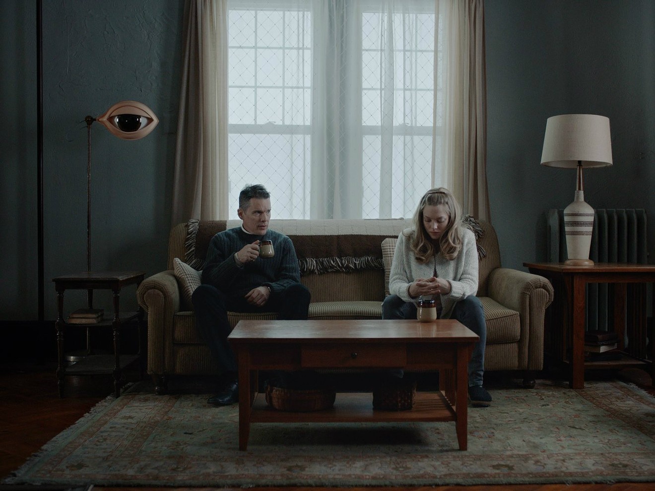 Ethan Hawke (left) plays Ernst Toller, a preacher losing his faith in his institution, and Amanda Seyfried is Mary, a pregnant parishioner who shakes off existential dread and soldiers on, in Paul Schrader’s First Reformed.