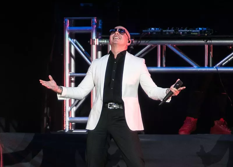 Image: Pitbull performing on stage at the American Airlines Arena (now known as the Kaseya Center) as part of Miami Bash on April 15, 2018.