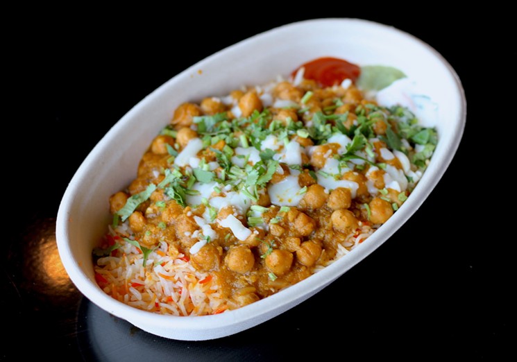 A channa masala bowl at Taco Masala lets you customize with add-on options like shredded cabbage, cilantro, and golden raisins. - PHOTO BY NICOLE DANNA