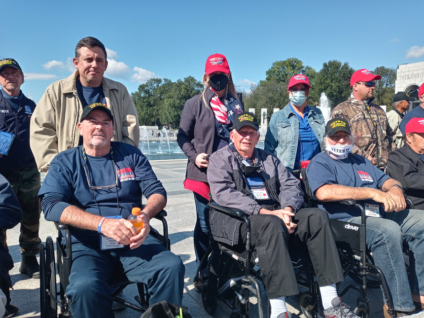 Veterans and their guardians traveling with Honor Flight South Florida, a nonprofit that honors military veterans with trips to monuments and memorials in the nation's capital. - PHOTO BY JOSHUA CEBALLOS