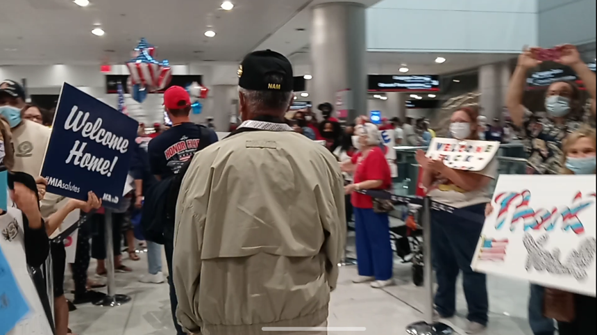 Angel Rodriguez returns to Miami International Airport to a reception of fanfare and applause from families who have come to welcome the local veterans back home. - PHOTO BY JOSHUA CEBALLOS