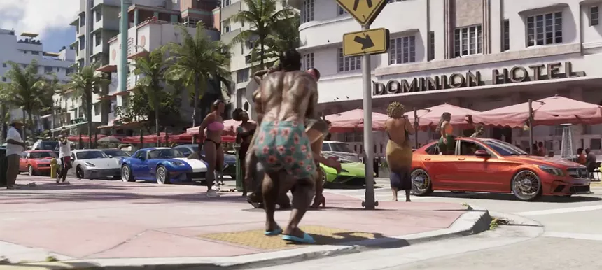 video game screenshot of an daylight outdoor scene with the exterior of an art deco hotel in the background